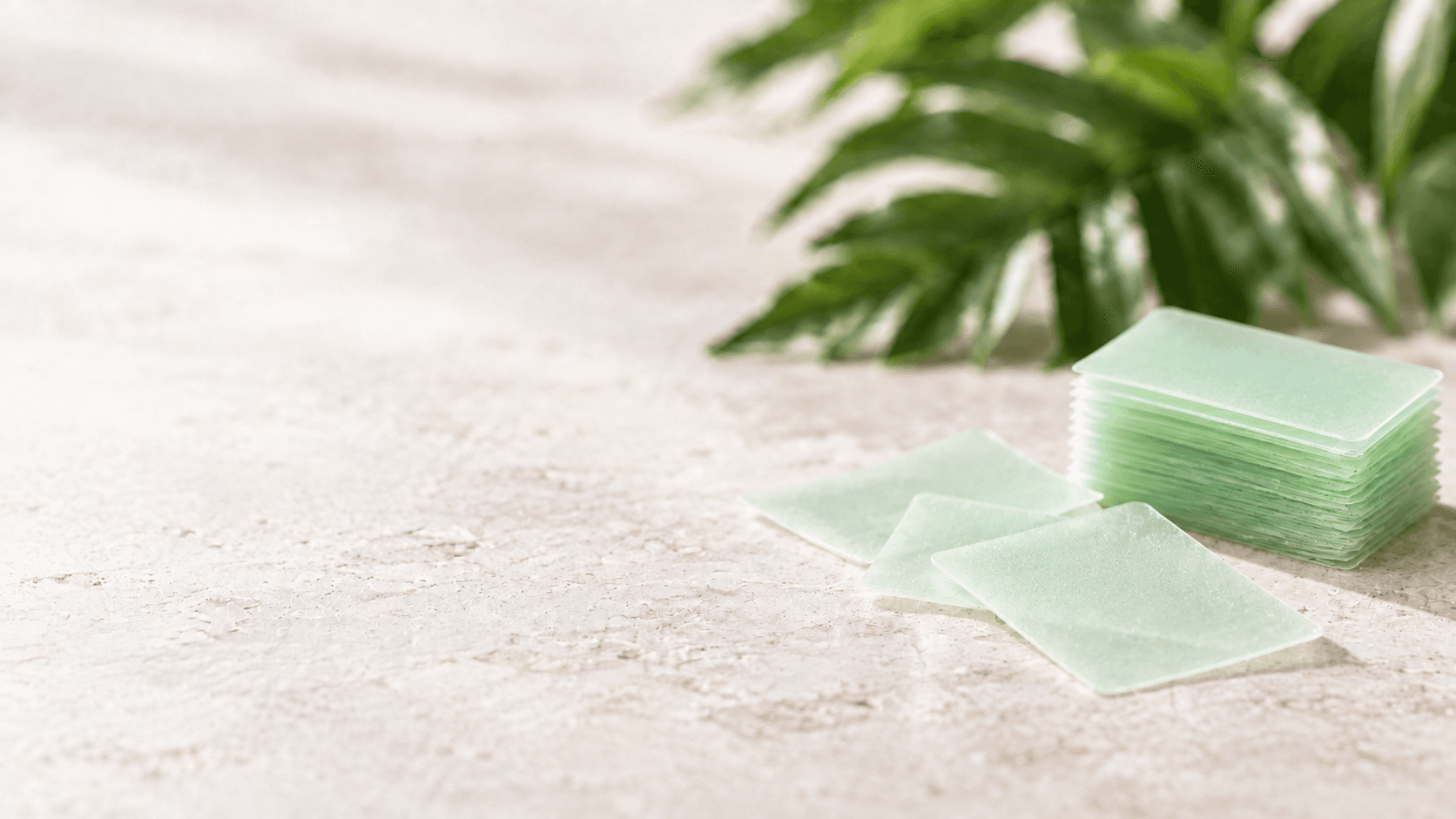 Pale green oral dissolving film strips on a stone tabletop